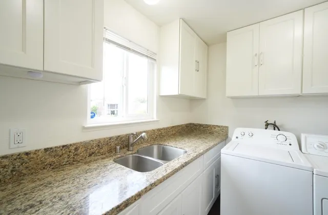 a view of a kitchen sink and cabinets