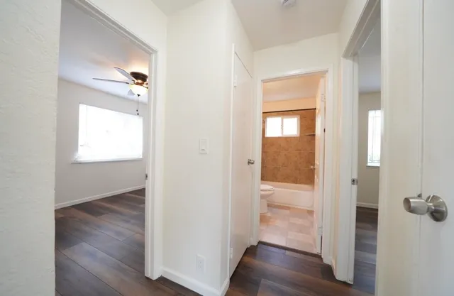 a view of a hallway with wooden floor