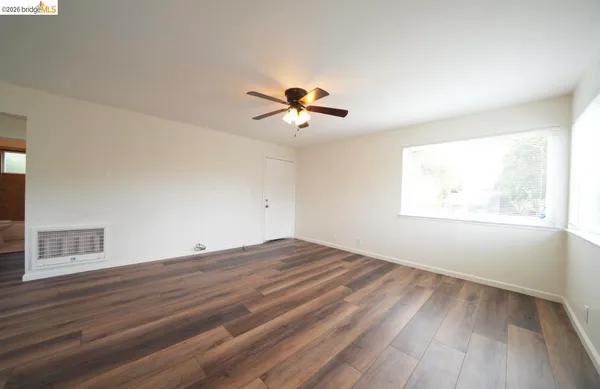 wooden floor in an empty room with a window