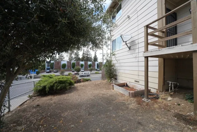 a view of a house with backyard and sitting area