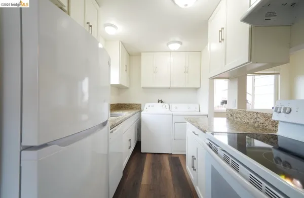 a kitchen with granite countertop a sink stainless steel appliances and cabinets