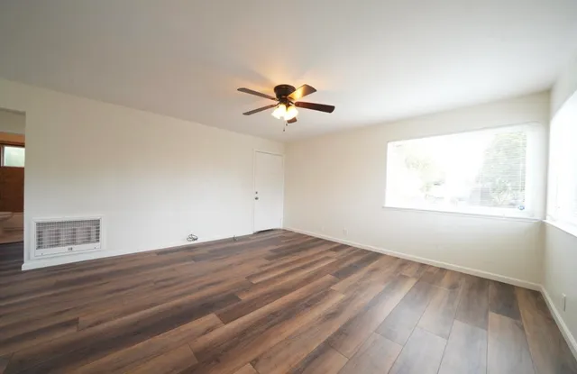 wooden floor in an empty room with a window