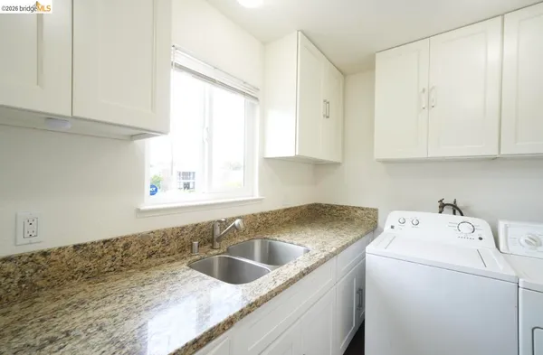 a view of a kitchen sink and cabinets