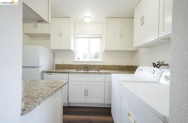 a kitchen with sink cabinets and utility
