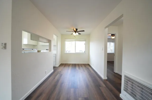 wooden floor in an empty room with a window