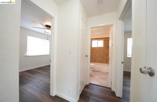 a view of a hallway with wooden floor