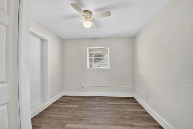 wooden floor in an empty room with a window
