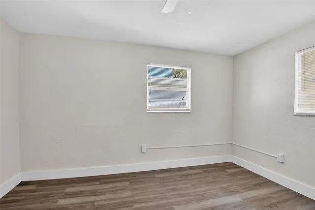 a view of a room that has wooden floor and window