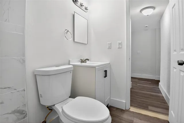 a white toilet sitting next to a bathroom sink