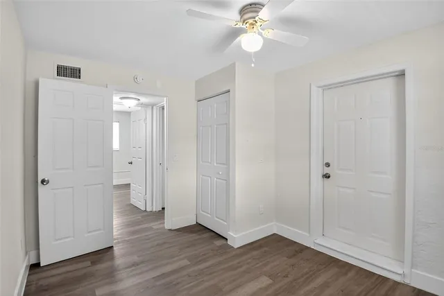 a view of an empty room with wooden floor