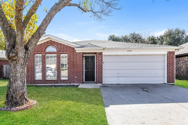 a front view of a house with a garden and yard