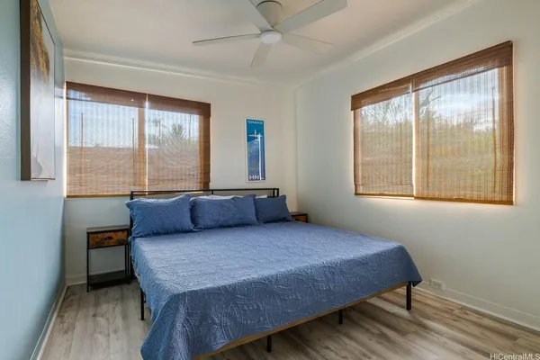 a bedroom with a bed and a large window