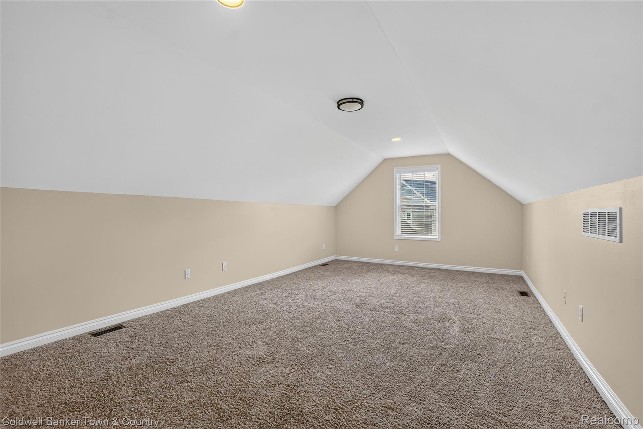 1725 Town Commons Drive Howell, MI 48855 - Photo 40 of 53 Spacious finished room with vaulted ceilings and neutral carpeting