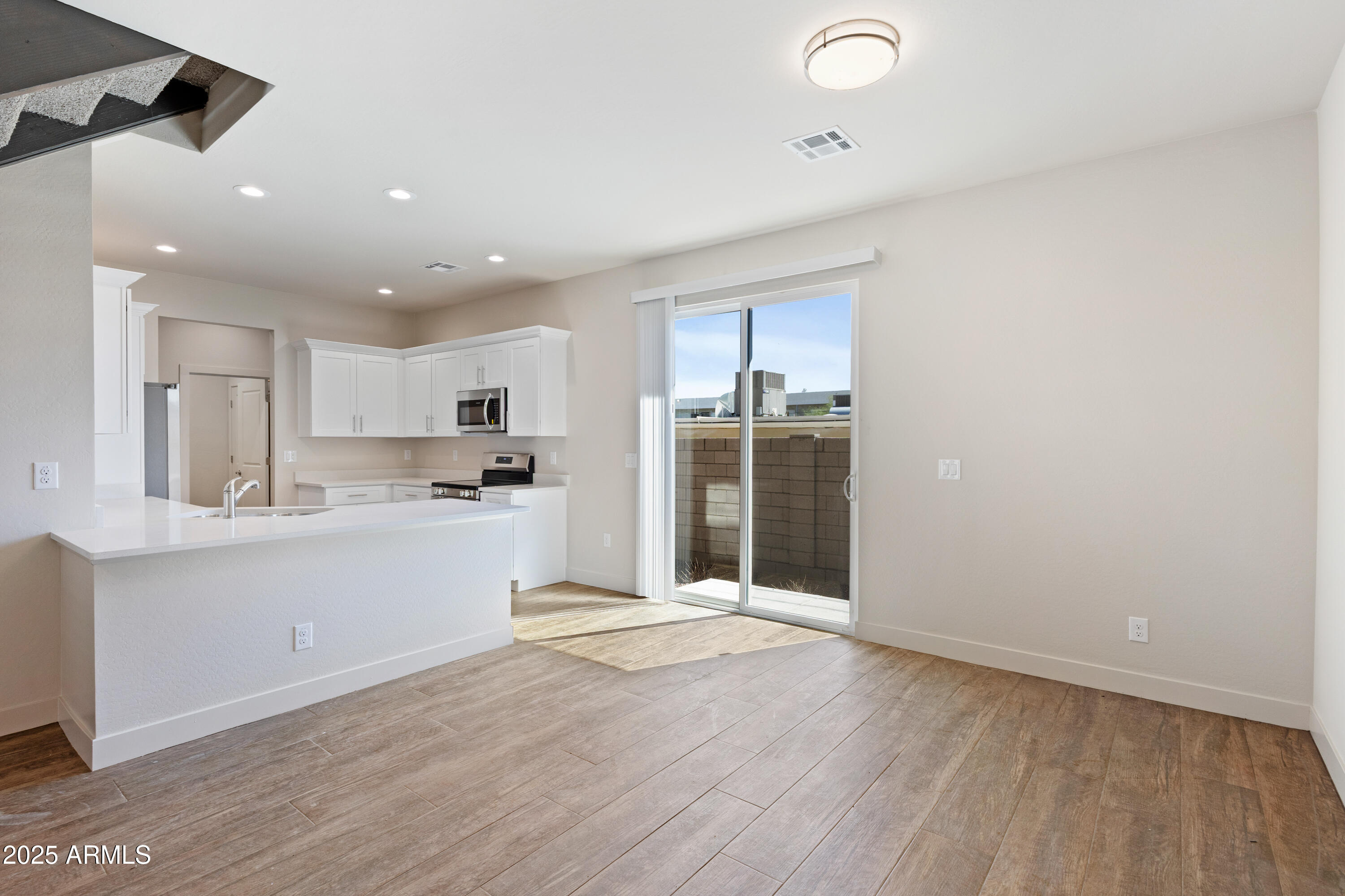 4307 North 13th Place Phoenix, AZ 85014 - Photo 9 of 35 a open kitchen with white cabinets and wooden floor