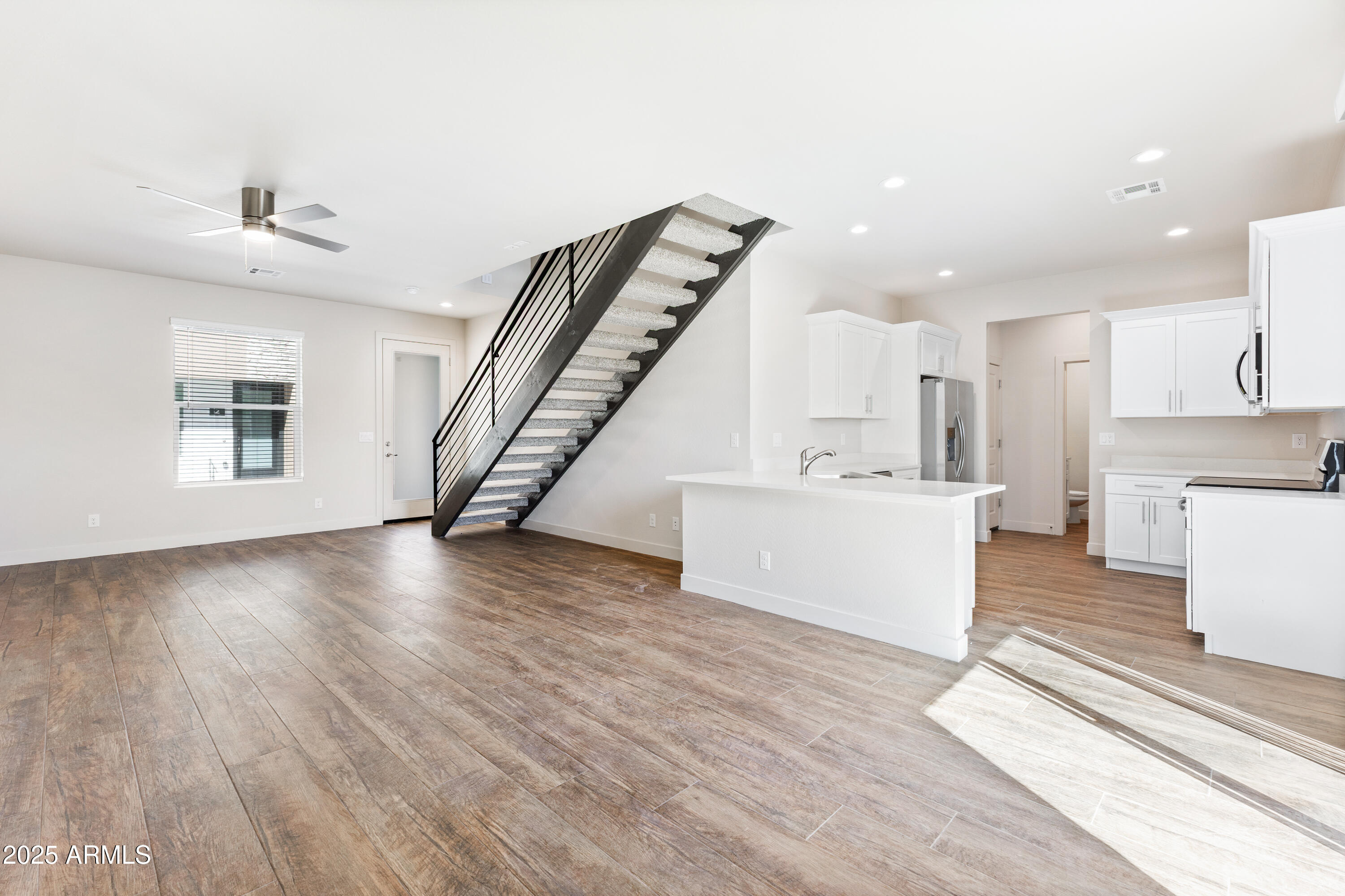 4307 North 13th Place Phoenix, AZ 85014 - Photo 11 of 35 a view of a livingroom with wooden floor and stairs