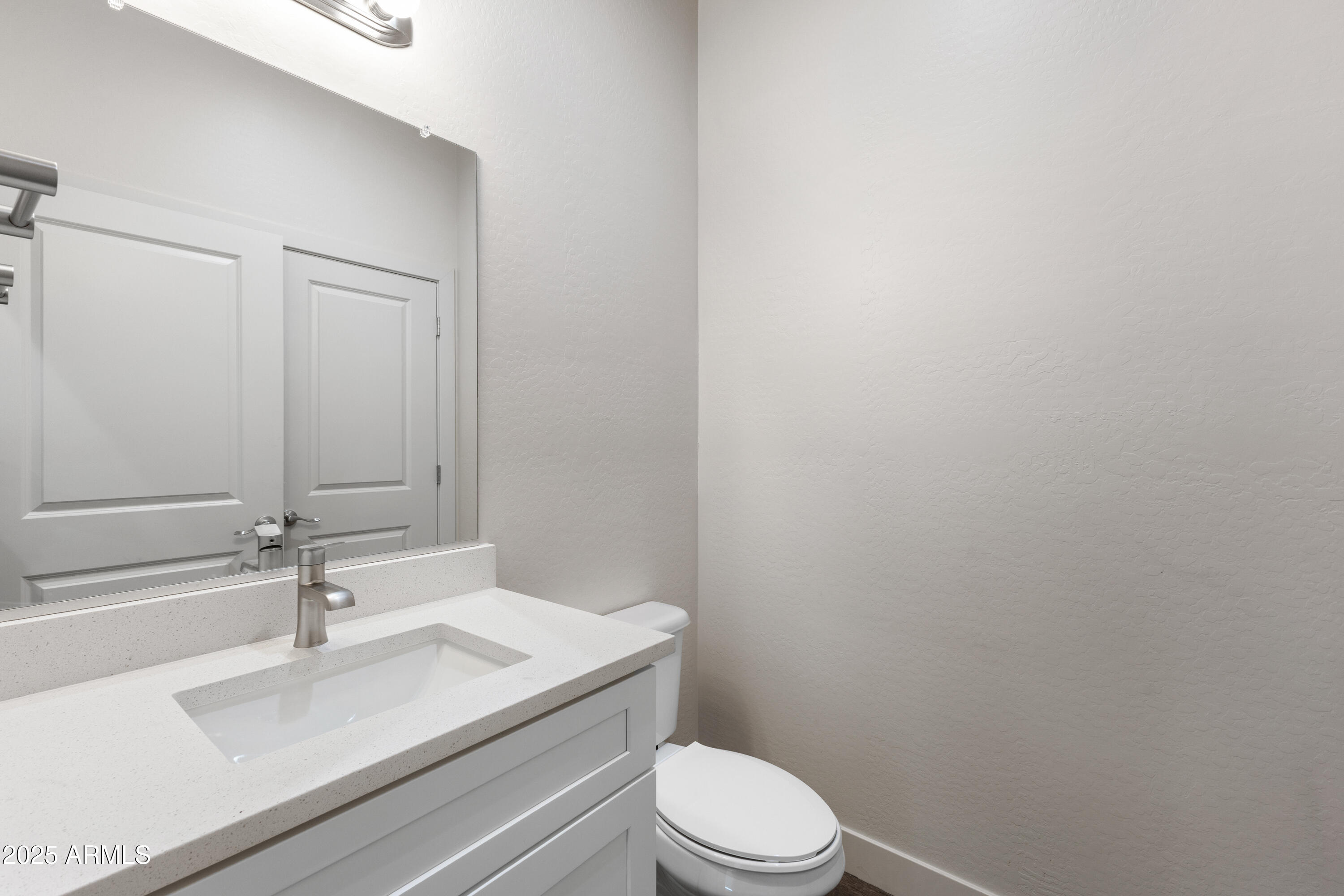 4307 North 13th Place Phoenix, AZ 85014 - Photo 17 of 35 a bathroom with a sink a toilet and a mirror