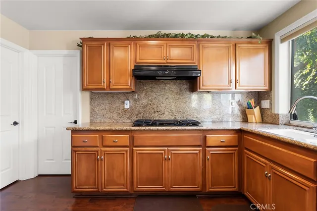 a kitchen with granite countertop a sink and cabinets
