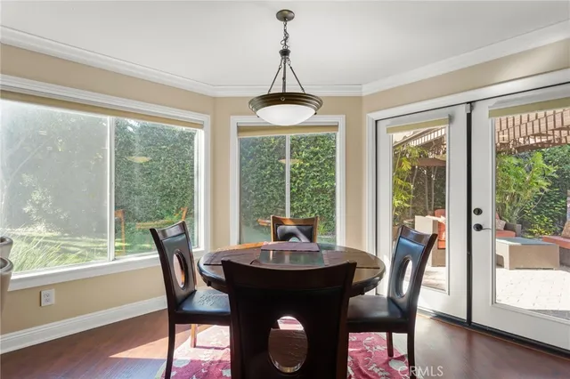 a dining room with furniture window and wooden floor