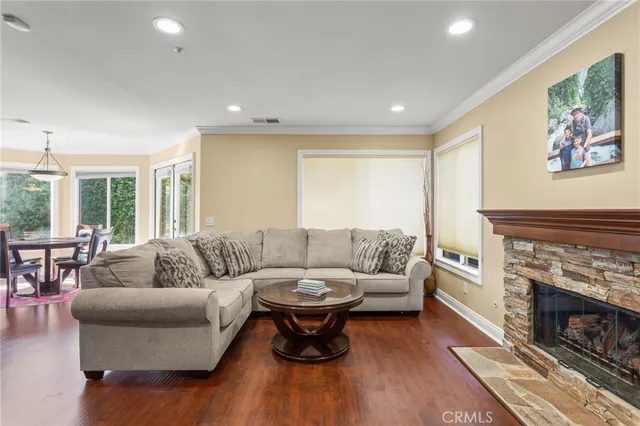 a living room with furniture a fireplace and a large window