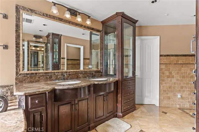 a bedroom with a bed and a refrigerator