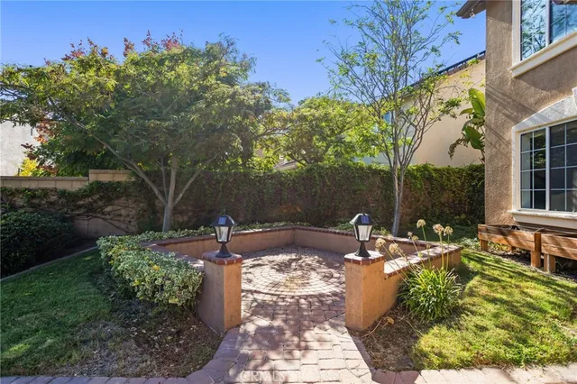 a backyard of a house with table and chairs