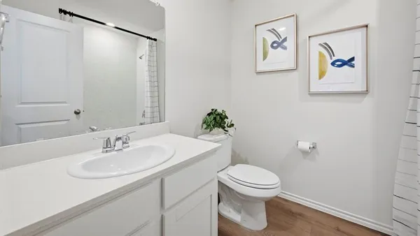 a bathroom with a sink mirror vanity and toilet