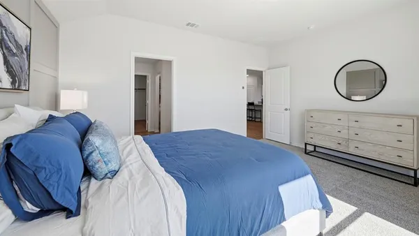 a bedroom with a bed and a dresser