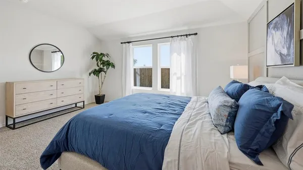 a bedroom with a bed and a dresser