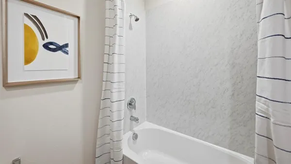 a bathroom with a bathtub and shower