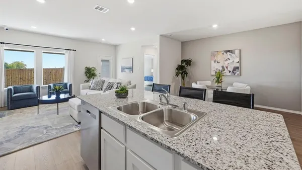 a kitchen with sink cabinets and living room