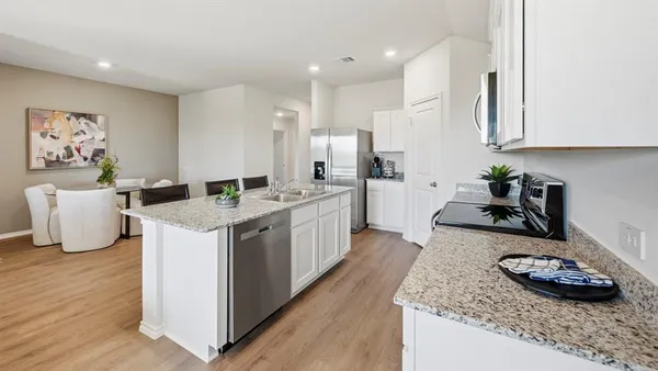 a kitchen with a sink stove and cabinets