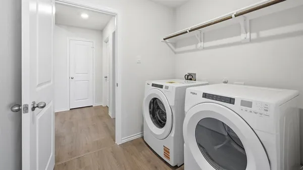 a view of a storage & utility room with dryer and washer