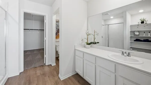 a bathroom with a double vanity sink a mirror and a shower