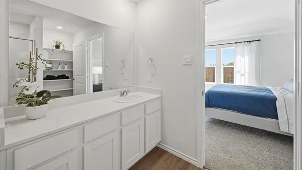 a bedroom with a bed and a sink