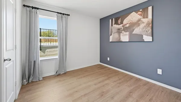 an empty room with windows and closet