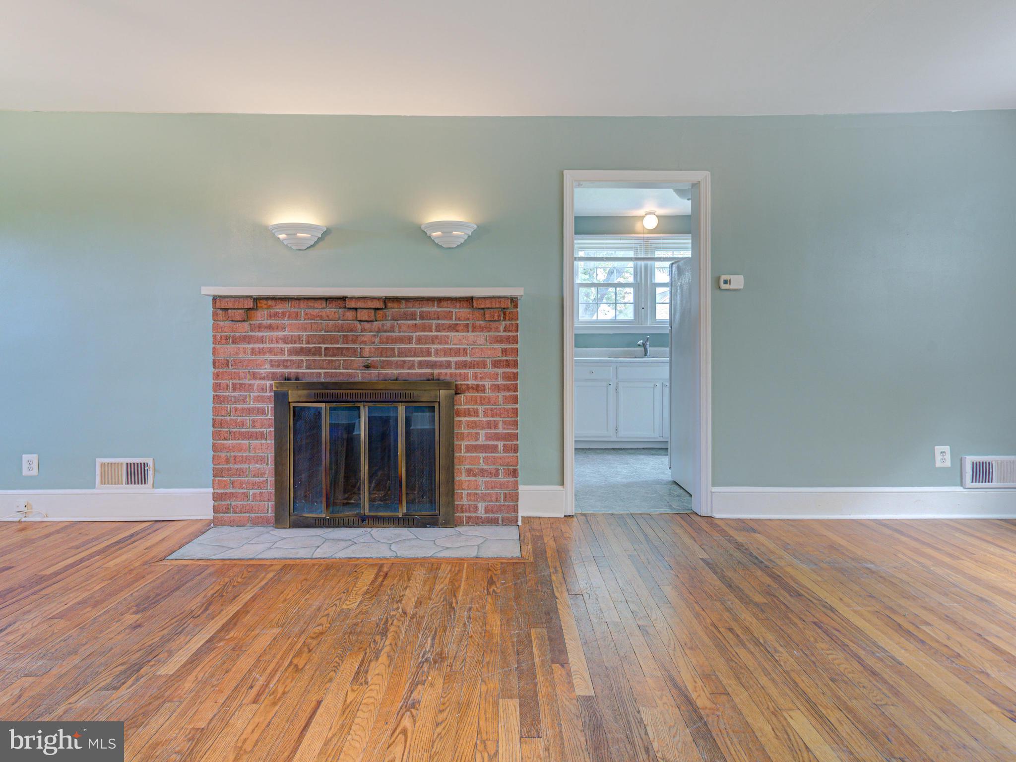 21148 Unison Road Middleburg, VA 20117 - Photo 13 of 52 Wood Burning Fireplace & Entrance to Kitchen