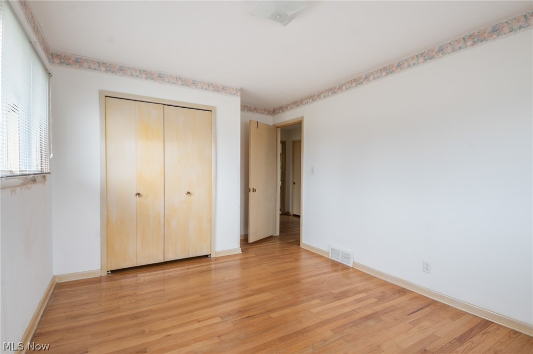 28879 Ridge Road Wickliffe, OH 44092 - Photo 17 of 34 Unfurnished bedroom with a closet and light hardwood / wood-style floors