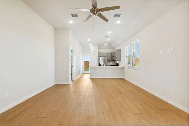 a view of a kitchen with a sink and wooden floor