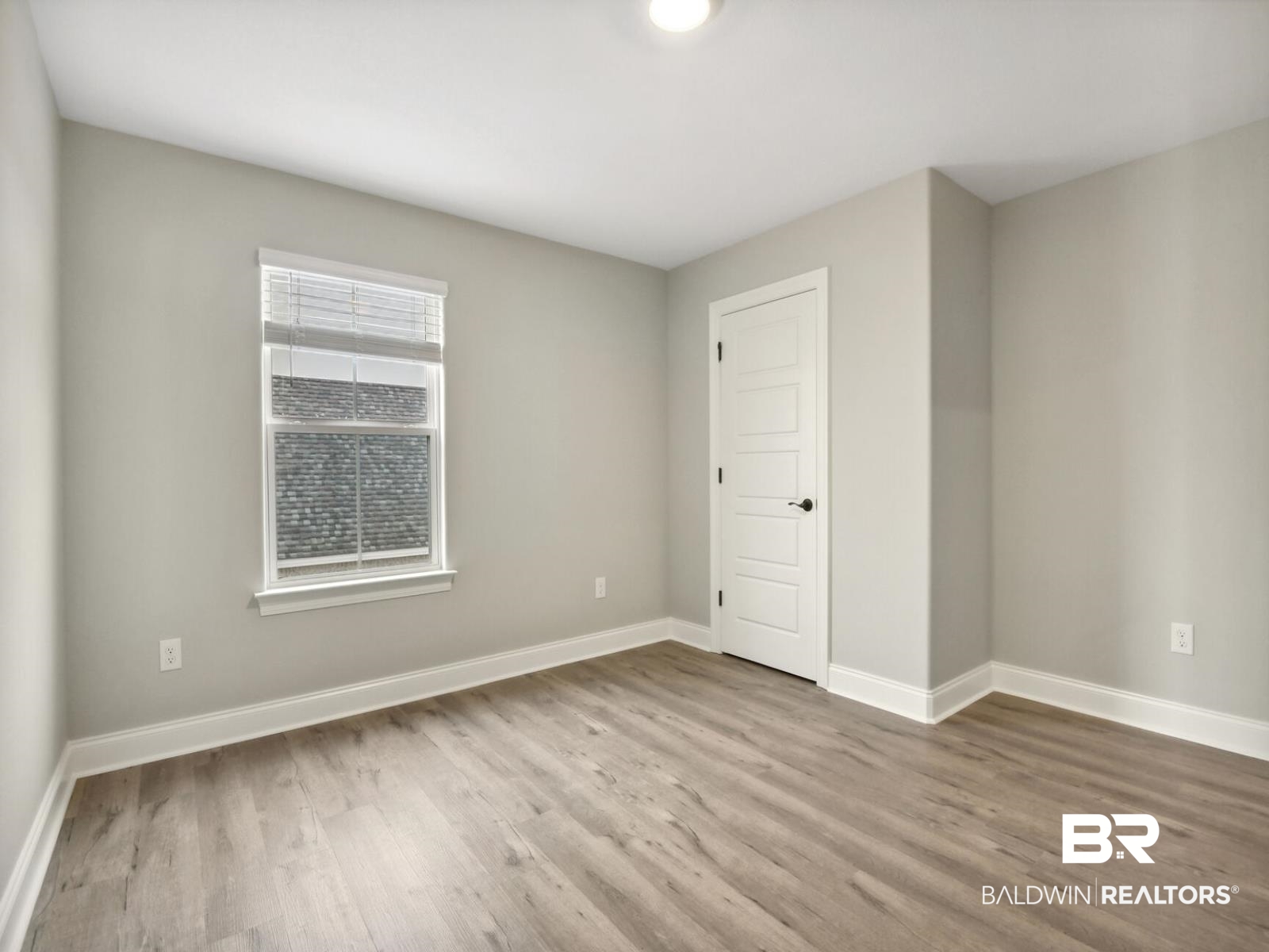 12922 Gondala Street Elberta, AL 36530 - Photo 5 of 20 Empty room featuring baseboards and light wood-type flooring