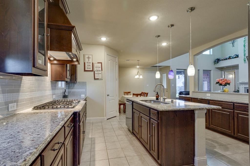 336 Red Hill Road Sunnyvale, TX 75182 - Photo 13 of 36 a kitchen with kitchen island granite countertop a sink stove and cabinets