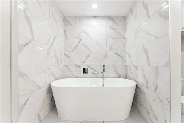 a white bath tub sitting in a bathroom