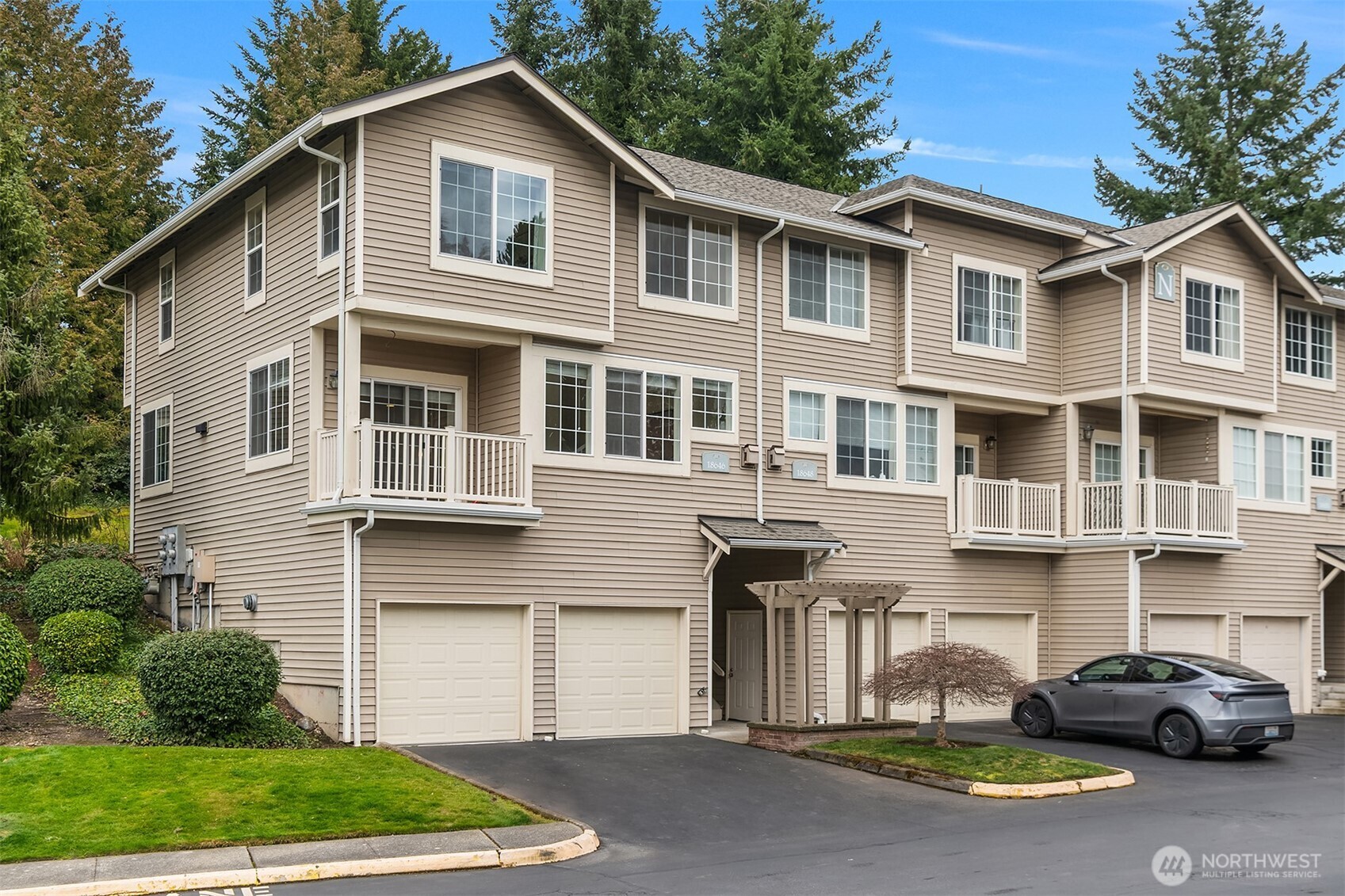 18646 Northeast 57th Way Redmond, WA 98052 - Photo 2 of 40 a front view of a house with a yard and garage