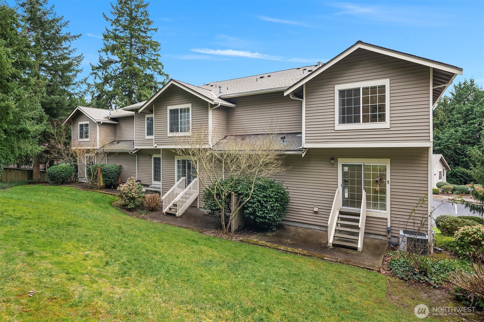18646 Northeast 57th Way Redmond, WA 98052 - Photo 26 of 40 a view of a house with a yard and lawn chairs with a yard