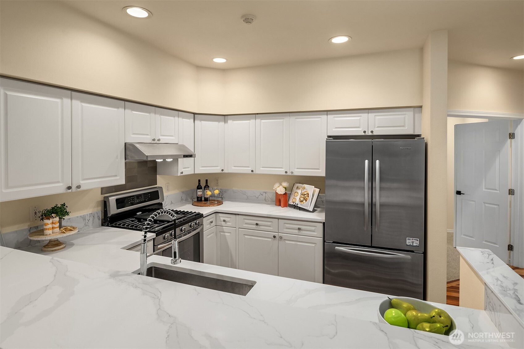 18646 Northeast 57th Way Redmond, WA 98052 - Photo 6 of 40 a kitchen with stainless steel appliances a refrigerator sink and cabinets