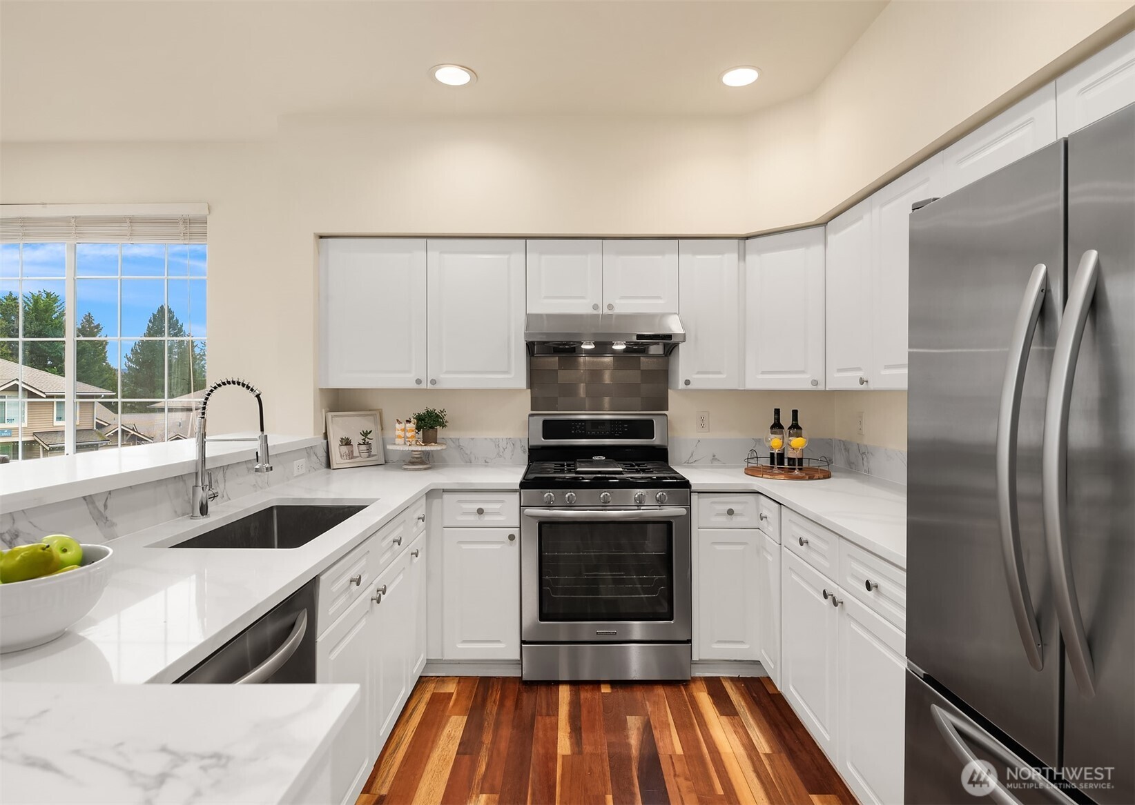 18646 Northeast 57th Way Redmond, WA 98052 - Photo 7 of 40 a kitchen with cabinets a sink and stainless steel appliances
