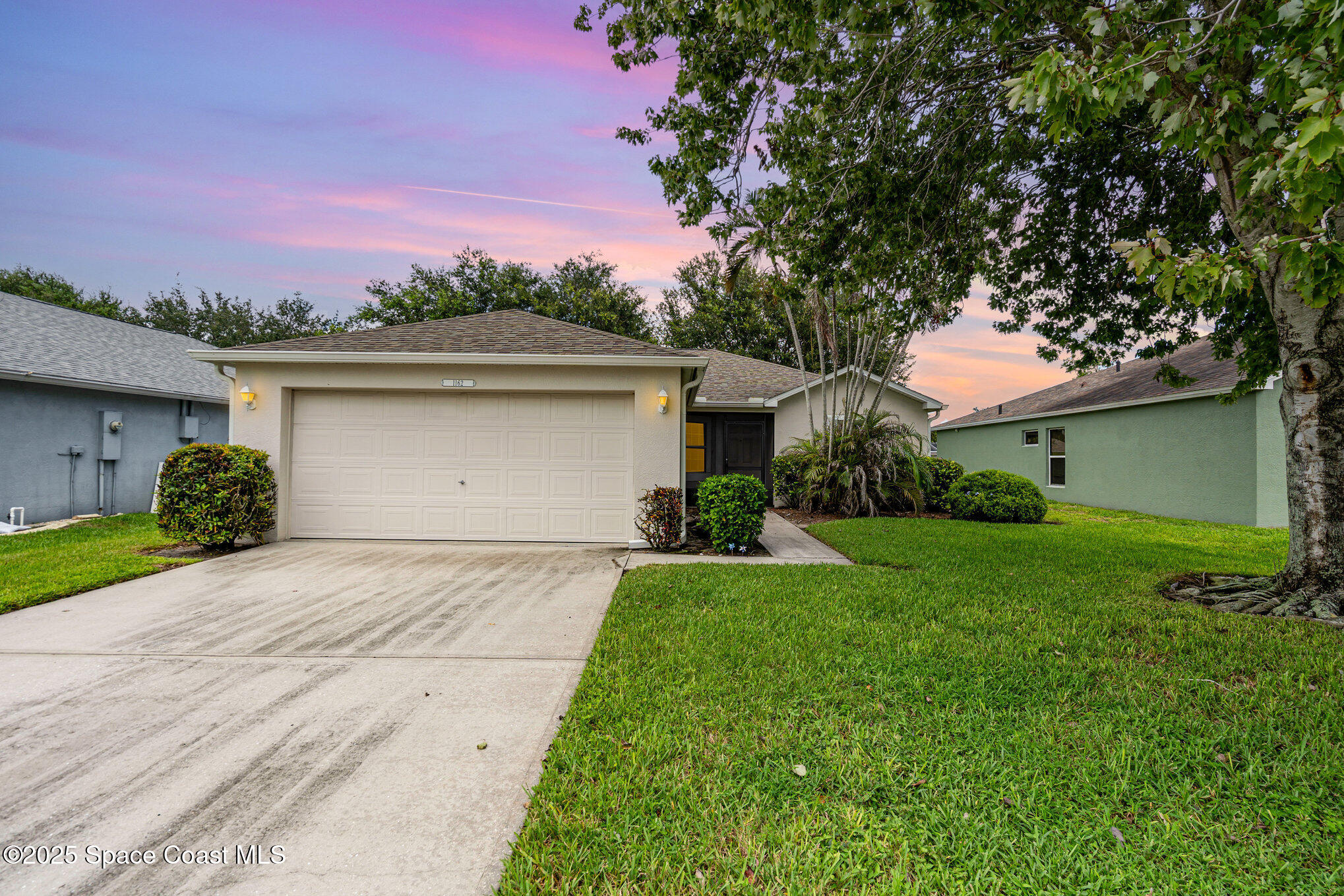 1162 Brumpton Place Rockledge, FL 32955 - Photo 4 of 25 a front view of a house with a yard and garage
