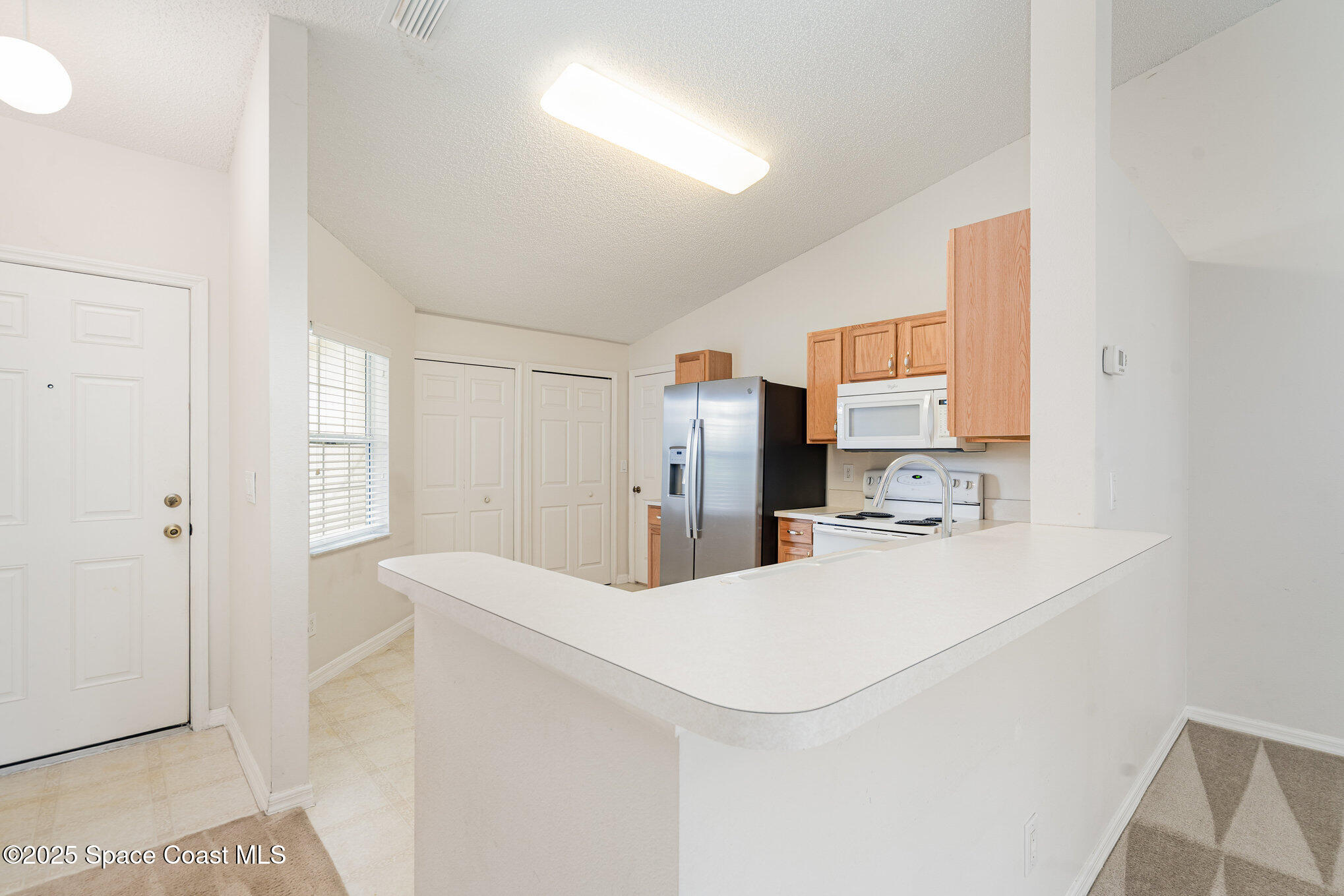 1162 Brumpton Place Rockledge, FL 32955 - Photo 5 of 25 a kitchen with stainless steel appliances a refrigerator and a stove