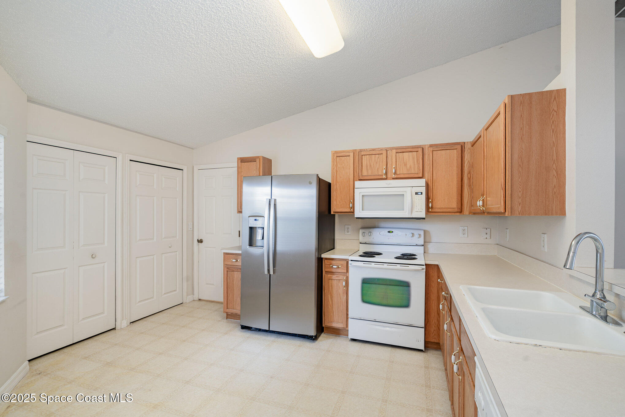 1162 Brumpton Place Rockledge, FL 32955 - Photo 6 of 25 a kitchen with a refrigerator sink and stove