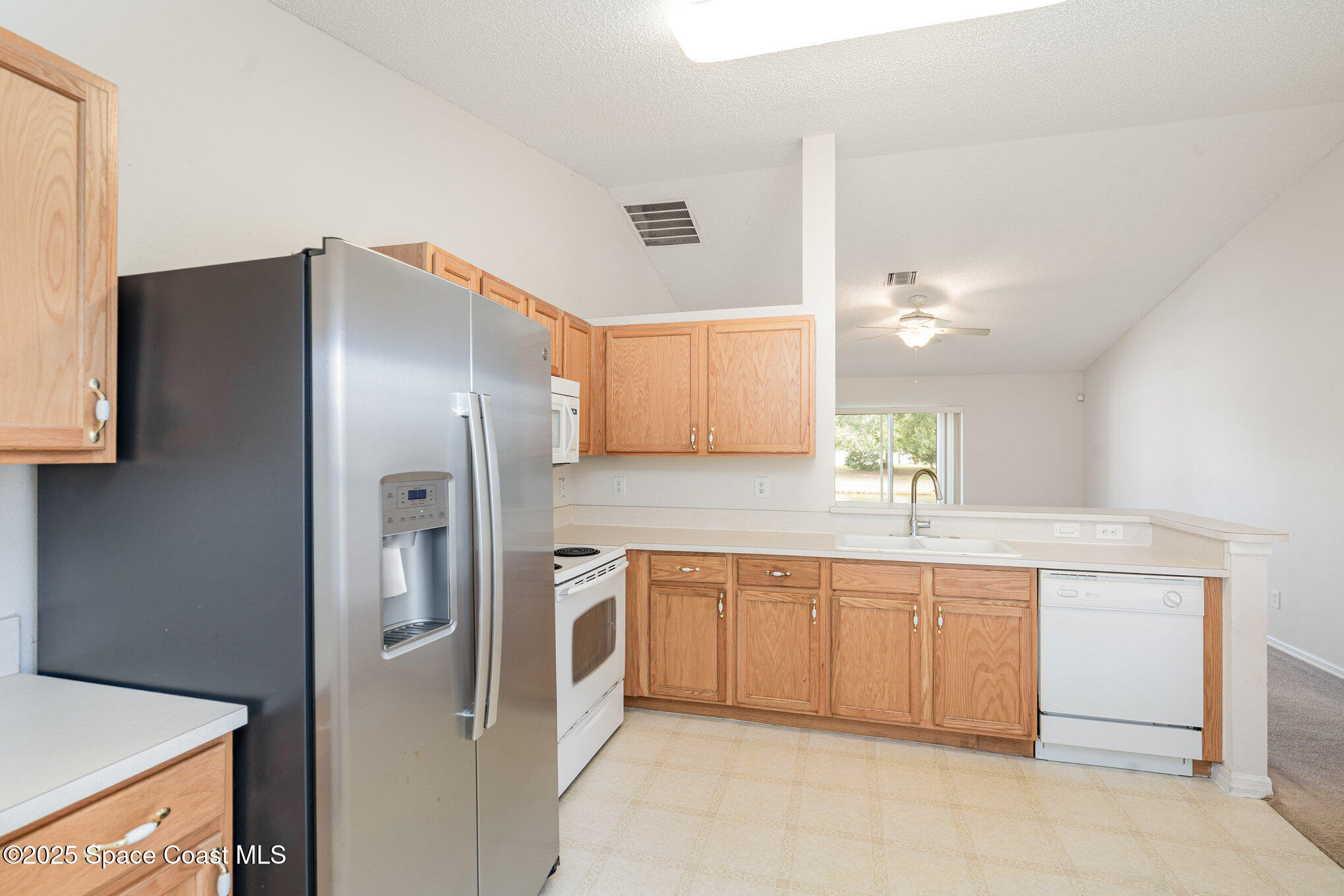 1162 Brumpton Place Rockledge, FL 32955 - Photo 7 of 25 a kitchen with stainless steel appliances a refrigerator sink and stove