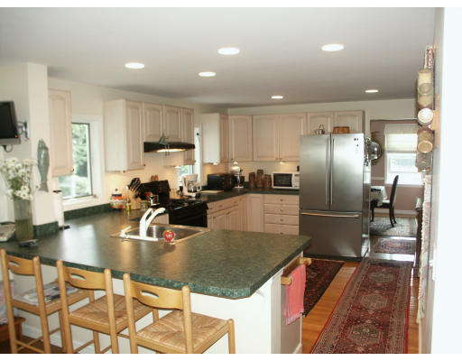 21 Columbia Road Marblehead, MA 01945 - Photo 6 of 9 a kitchen with kitchen island a counter top space a sink stainless steel appliances and cabinets
